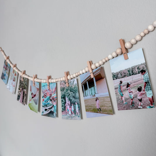 String of photos with wooden clips 
